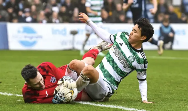 Ross County goalkeeper Ross Laidlaw clutches the ball under pressure from Celtic's Yang Hyun-jun