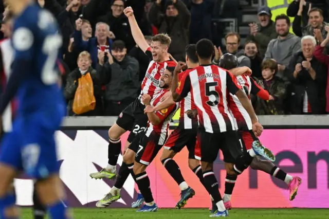 Nathan Collins celebrates with his Brentford team-mates after scoring