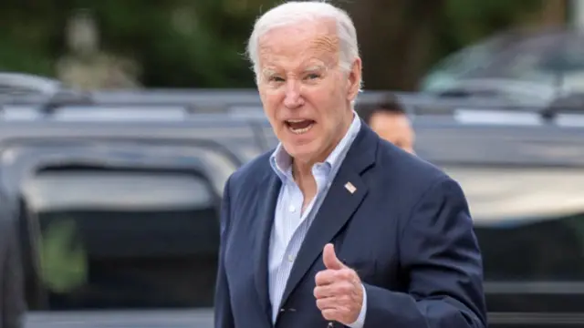 US President Joe Biden gives a thumbs-up in response to a question about progress on a "humanitarian pause"