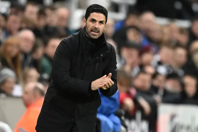 Arteta claps on the touchline.