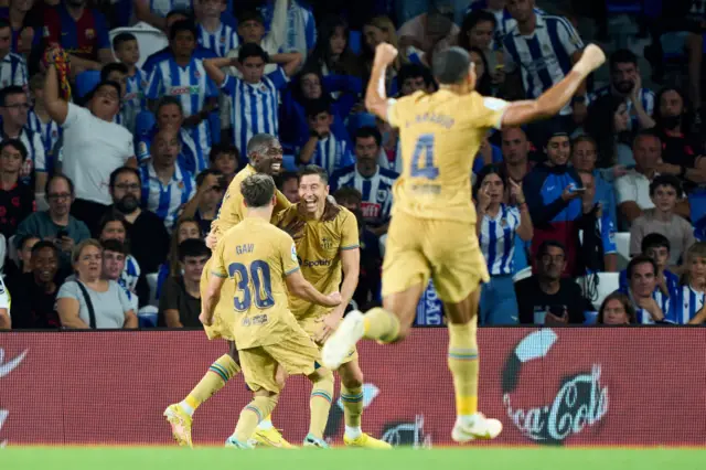 Robert Lewandowski celebrates with his Barcelona teammates after scoring at Real Sociedad