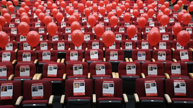 Images and balloons in a Jerusalem convention centre mark the plight of around 240 hostages held in Gaza