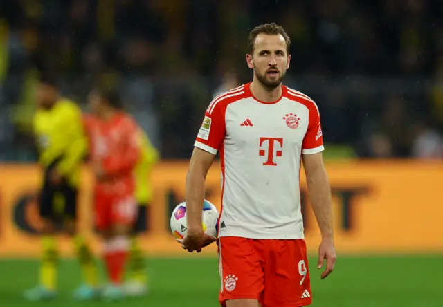 Kane holds the match ball after scoring his hat trick.