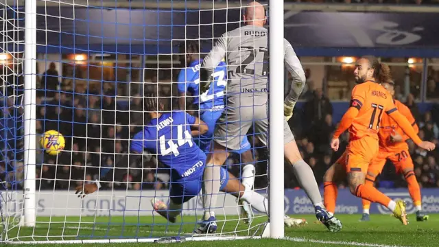 The ball goes into the net for Ipswich to score