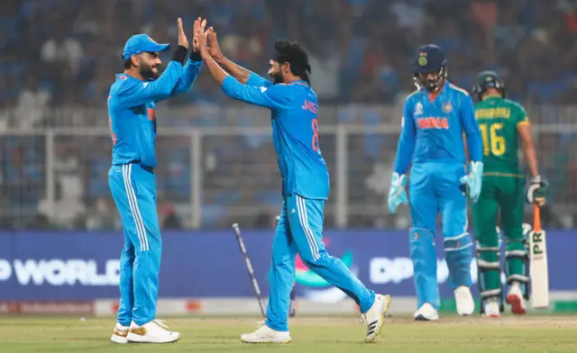 Ravi Jadeja of India celebrates the wicket of Keshav Maharaj of South Africa with team mate Virat Kohli