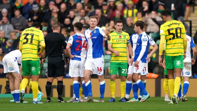 Players gather round the referee as Scott Wharton is sent off