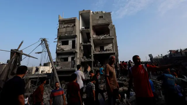 People gather at al-Maghazi refugee camp on Sunday morning