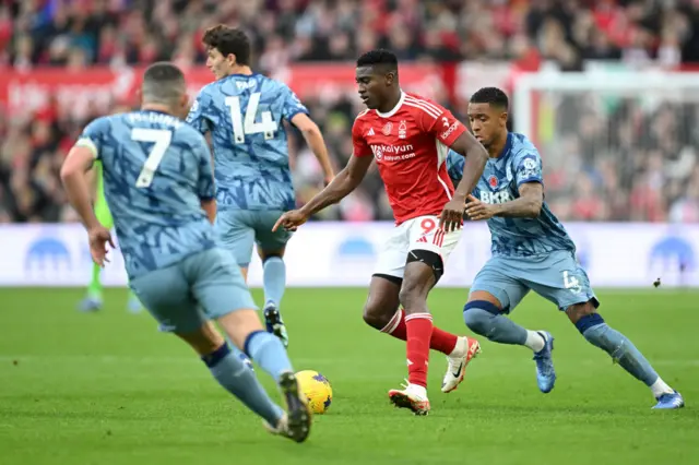 Taiwo Awoniyi of Nottingham Forest on the ball whilst under pressure from Ezri Konsa