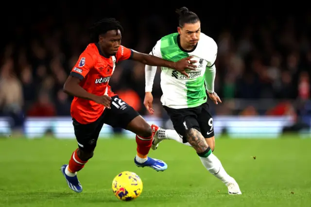 Issa Kabore of Luton Town challenges for the ball with Darwin Nunez