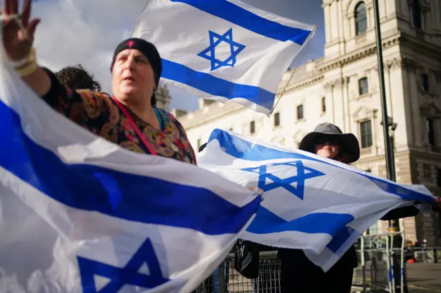 People take part in a pro-Israel rally in Parliament Square in London