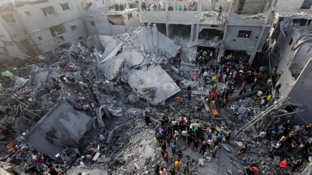 Palestinians search for casualtie at the al-Maghazi refugee camp