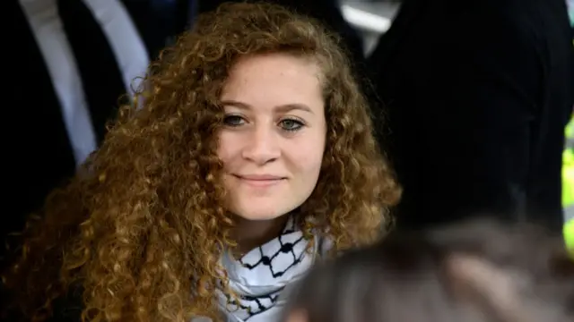 Tamimi smiles in a crowd