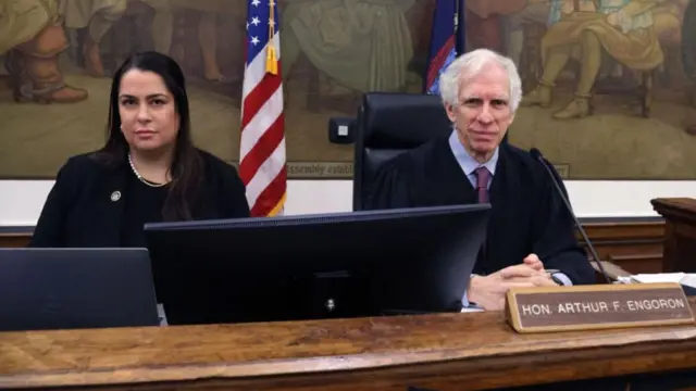 Judge Engoron sitting with his legal clerk in courtroom