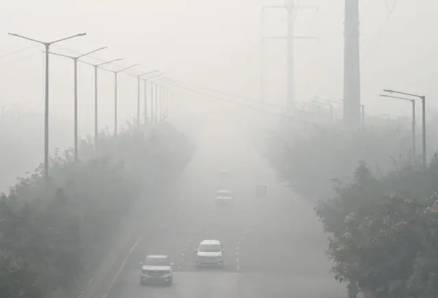 Commuters out on a smoggy morning amid rising air pollution levels on November 5, 2023 in Noida, India. Stringent measures were enforced in Delhi as the air quality deteriorated to 'severe plus' levels due to unfavorable winds and increased farm fires across northern India. The toxic haze persisted over Delhi-NCR for the sixth consecutive day, posing significant challenges for individuals with respiratory problems.