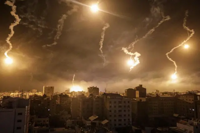 Israeli army flares illuminate the sky over west Gaza in the northern Gaza Strip