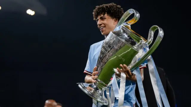 Rico Lewis with the Champions League trophy