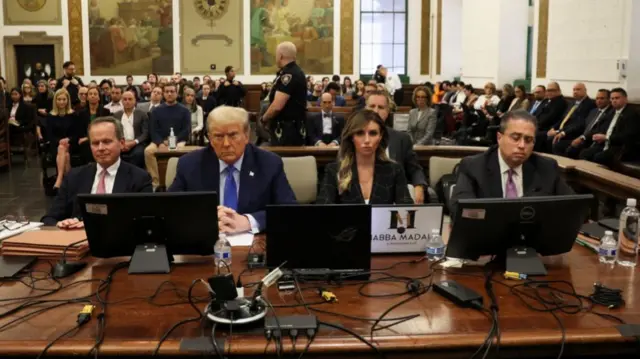 Donald Trump in New York State Supreme Court surrounded by his three lawyers on both sides