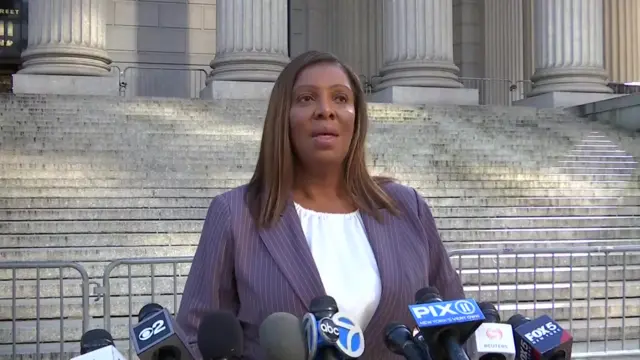 New York Attorney General Letitia James standing outisde the courthouse, microphones from many media organisations are in front of her