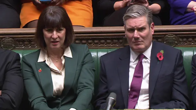 Keir Starmer sits on the opposition bench, watching Rishi Sunak address Commons