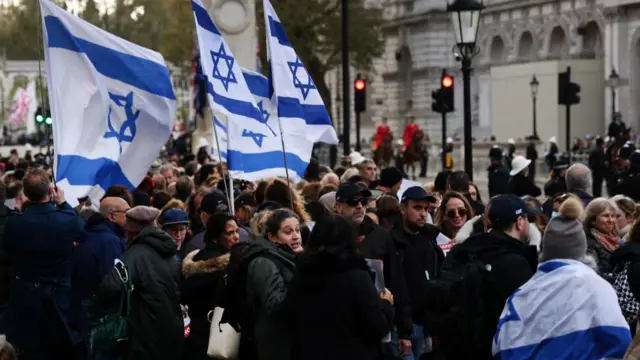 People hold Israeli flags during a vigil for Israeli victims held outside Downing Street in London, Britain, 07 November 2023, to mark one month since the Hamas attacks in Israel