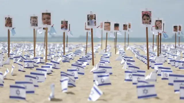 Israeli flags and pictures symbolising victims are placed in Copacabana beach by NGO Rio de Paz, one month on from the October 7th attack by the Palestinian Islamist group Hamas, in Rio de Janeiro, Brazil November 7, 2023.