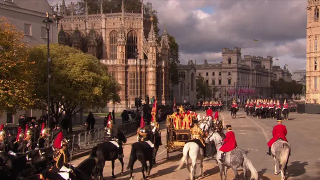 King and Queen leave in carriage