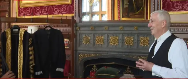 Sir Lindsay Hoyle standing next to the robes he will wear for the opening of Parliament