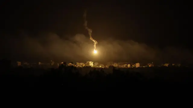 A flare illuminates the sky over the northern Gaza strip, taken from Sderot in Israel