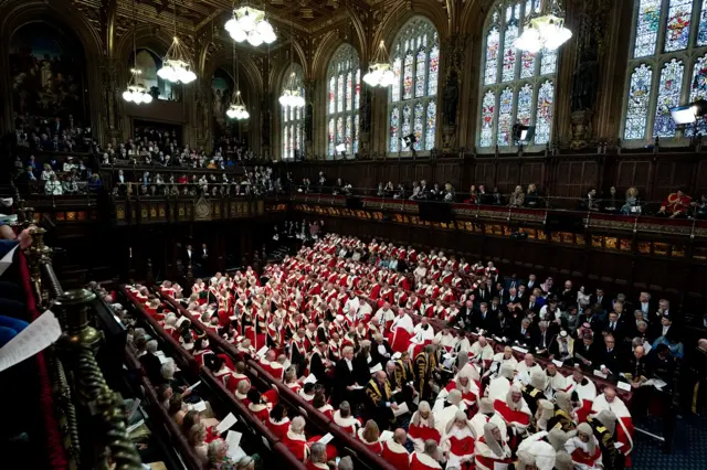 Members of the House of Lords await the start of the State Opening of Parliament,