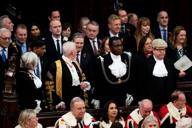 Sunak and Starmer stand among other senior MPs at the ceremony