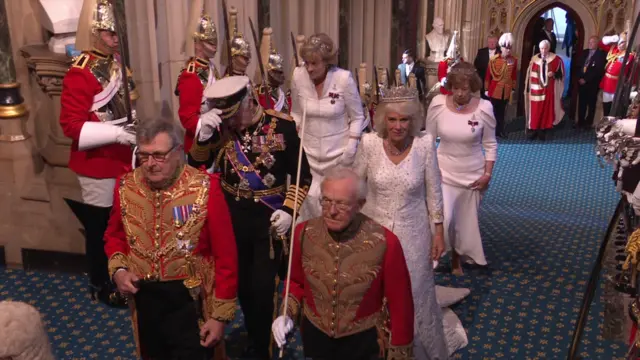 MPs are summoned to the Lords by Black Rod, an official position currently held by Sarah Clarke.  Before entering the House of Commons, Black Rod has the door shut in their face, symbolising the chamber's independence from the monarchy.