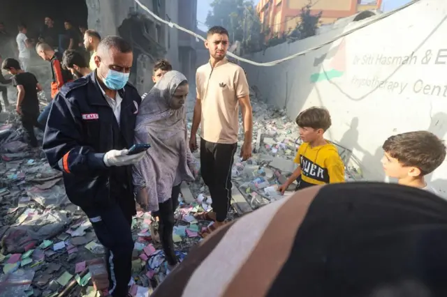 Palestinians react at the site of Israeli strikes on a residential building, amid the ongoing conflict between Israel and Palestinian Islamist group Hamas, in Khan Younis in the southern Gaza Strip, November 7, 2023