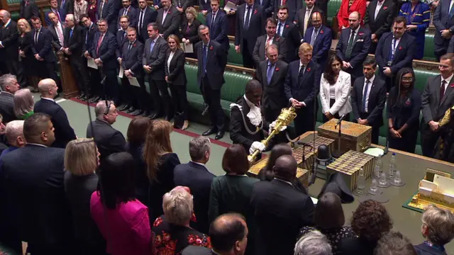 Ceremonial mace is placed in a packed Commons