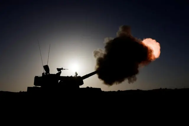 An Israeli military unit fires from an undisclosed location near the Gaza Strip