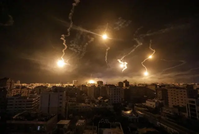 Israeli army flares illuminate the sky over west Gaza in the northern Gaza Strip