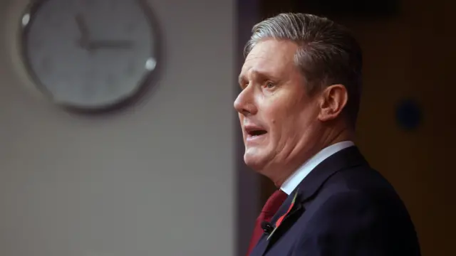 Labour leader Keir Starmer side profile. He is speaking and his mouth is open