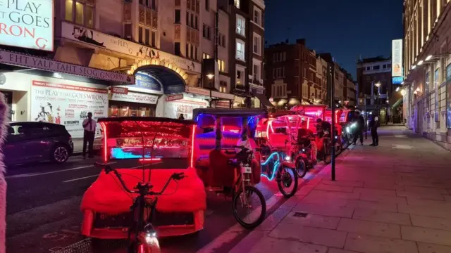 A row of pedicabs outside a theatre in central London