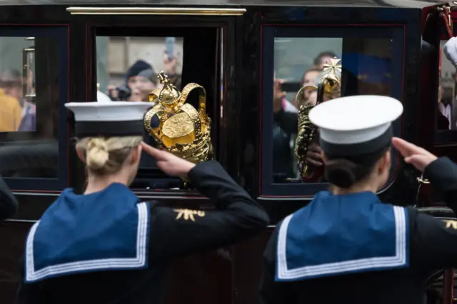 The coach carrying the royal regalia travels along Whitehall during the State Opening of Parliament in 2019