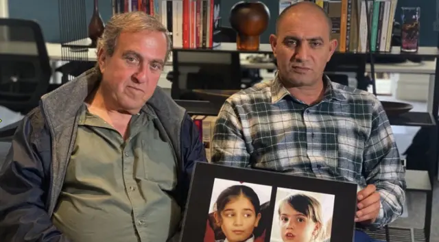 Fathers Bassam Aramin, a Palestinian Muslim, and Rami Elhanan, an Israeli Jew, pose with a photo of their daughters Abir and Smadar