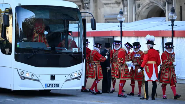 Yeomen of the Guard exciting a white coach