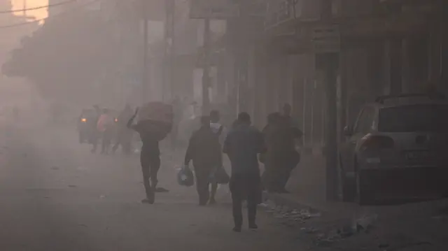 People flee their homes on the edges of Beach refugee camp, in Gaza City,