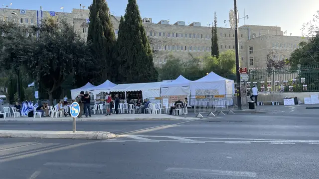 Tents set up by protesters across the road from Israel's parliament, the Knesset.