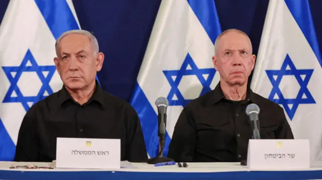 Israel's Defence Minister Yoav Gallant sits next to PM Benjamin Netanyahu