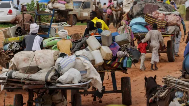 Chadian cart owners transport belongings of Sudanese people who fled the conflict in Sudan's Darfur region, while crossing the border between Sudan and Chad in Adre, Chad August 4, 2023.