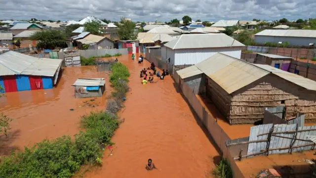 A picture taken with a drone of people walking in the flooded streets of Baidoa town, the administrative capital of Southwest State in Somalia, 06 November 2023.