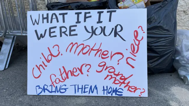 Placard asking what people would do if it was their family member held hostage by Hamas