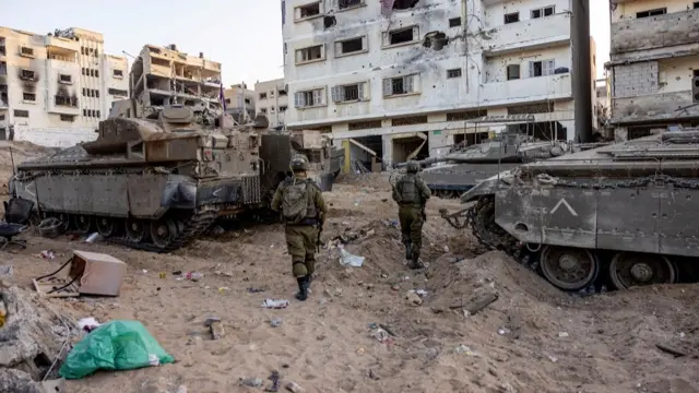 Israeli soldiers walk through rubble, amid the ongoing ground invasion against Palestinian Islamist group Hamas in the northern Gaza Strip, November 8, 2023. REUTERS/Ronen Zvulun. EDITOR’S NOTE: REUTERS PHOTOGRAPHS WERE REVIEWED BY THE IDF AS PART OF THE CONDITIONS OF THE EMBED. NO PHOTOS WERE REMOVED.