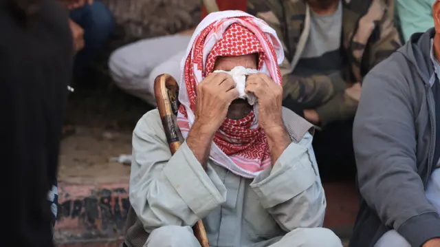 A Palestinian man from the Abu Taim family wipes his tears as bodies are collected for burial from the al-Nasser hospital in Khan Yunis in the southern Gaza Strip on November 9, 2023, amid the ongoing battles between Israel and the Palestinian group Hamas. Israeli air strikes pounded Gaza City on November 9, as soldiers battled street-by-street with Hamas militants, and tens of thousands of Palestinians desperate for safety fled their homes southwards in the besieged territory.