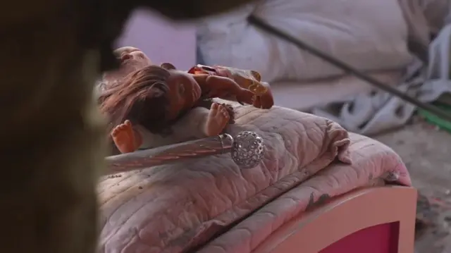 A doll on a child's bed