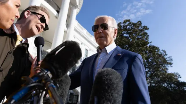 US President Joe Biden speaks to members of the news media as he departs the South Lawn of the White House